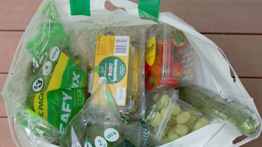 a bag of plastic wrapped fresh vegies
