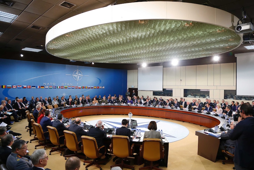 NATO Secretary General Jens Stoltenberg addresses the NATO defence meeting.