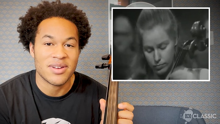 Sheku Kanneh-Mason holds a cello and looks at the camera. There is also a rectangle showing a video of Jacqueline Du Pre.