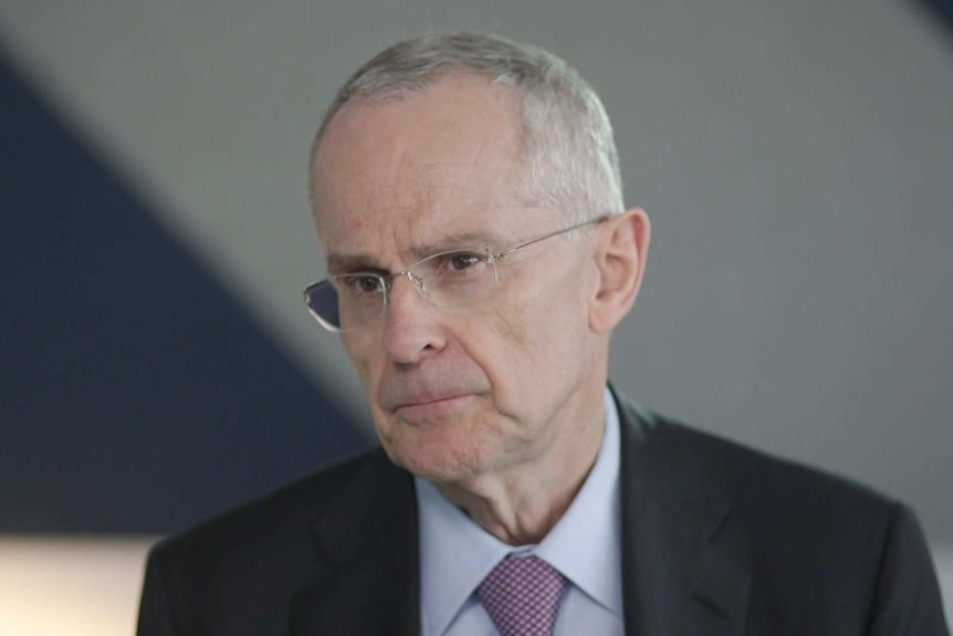 Head shot of Rod Sims, ACCC Chairman, sitting in front of a blurry office background