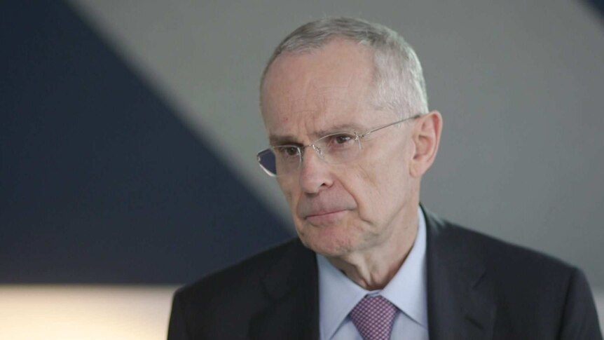 Head shot of Rod Sims, ACCC Chairman, sitting in front of a blurry office background