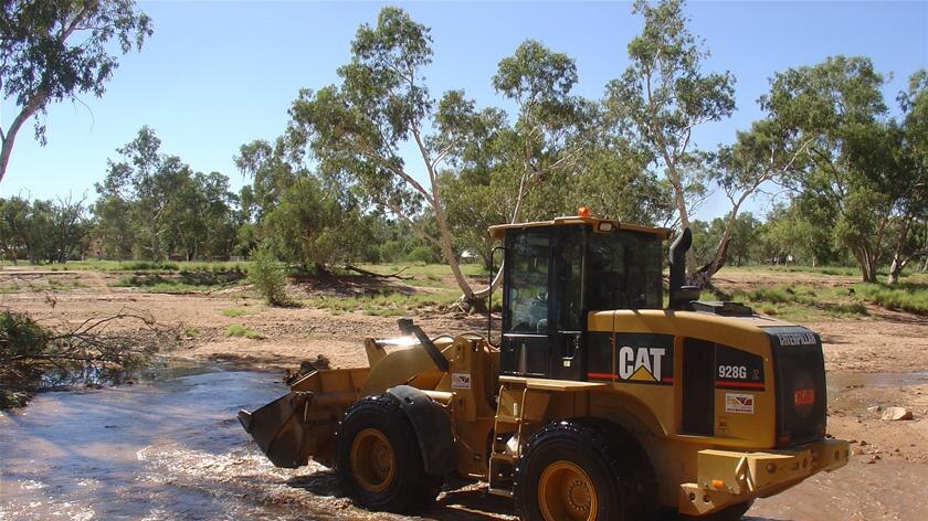 Three weeks after a major flow in the Todd River work is still being done to remove silt and debris
