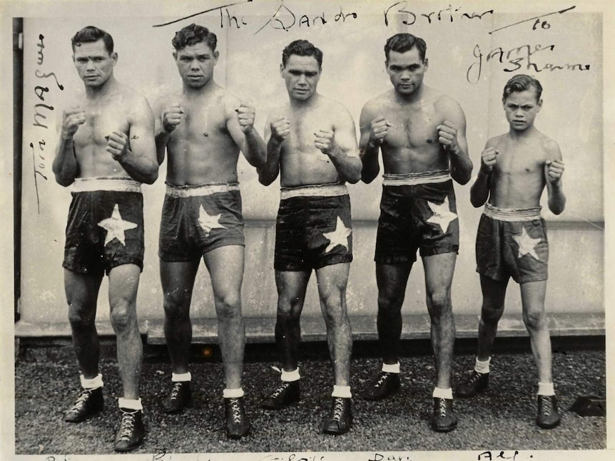 Aboriginal Boxer, Dave Sands stands alongside his brothers.