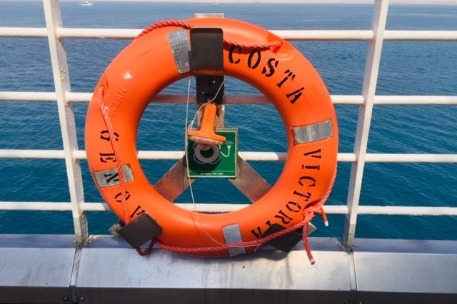 An orange lifebuoy with the words 'Costa Victoria' on it.