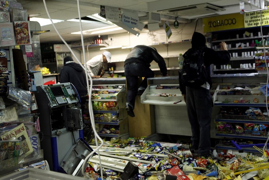 Looters raid a store in Hackney, east London, during rioting