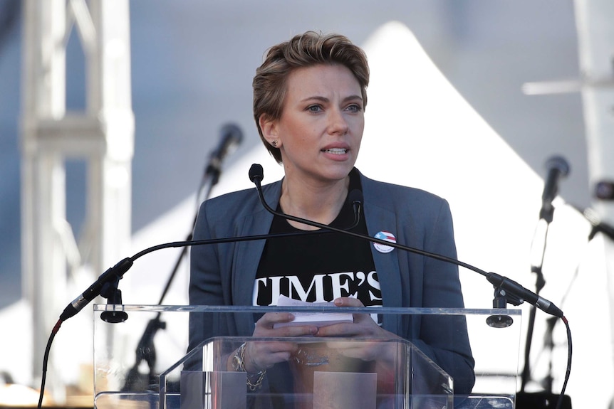 Actress Scarlett Johansson, wearing a Time's Up shirt, speaks at a Women's March.