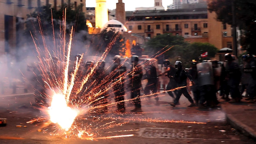 Anti-government protesters use fireworks against Lebanese riot police in Beirut.
