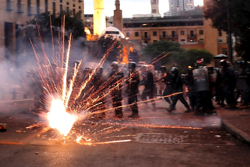 Anti-government protesters use fireworks against Lebanese riot police in Beirut.