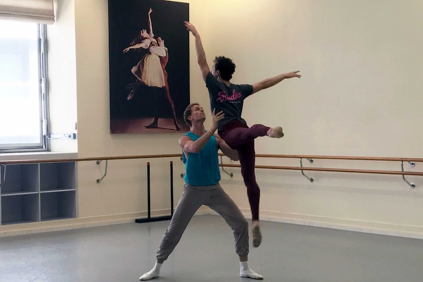 Two male ballet dancers, Marcus Morelli and Adam Bull dancing together.