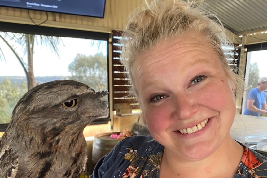 A woman holding a bird