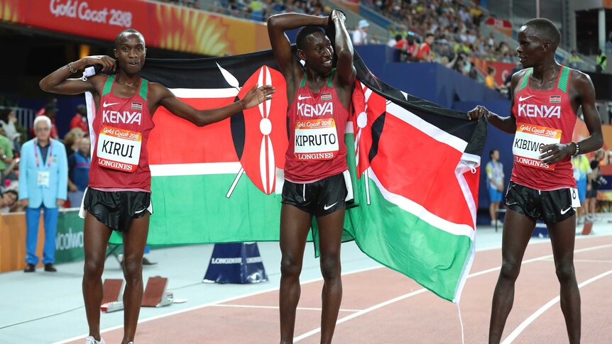 Kenya's Conseslus Kipruto (C), Abraham Kibiwott and Amos Kirui celebrate after the men's 3,000m steeplechase.