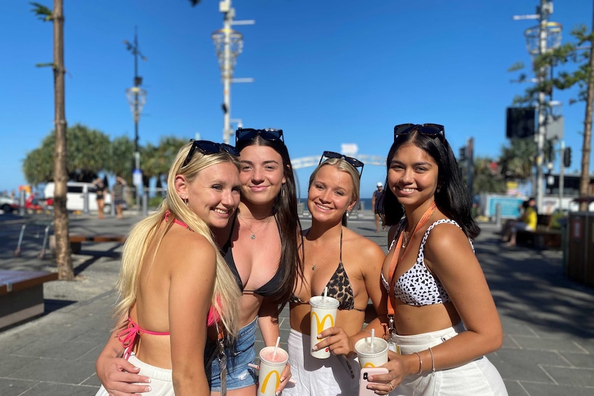 four young women smiling at camera