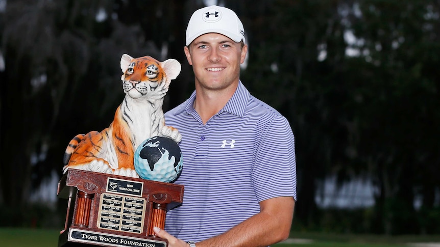Jordan Spieth poses with the winner's trophy after his win in the 2014 Hero World Challenge.