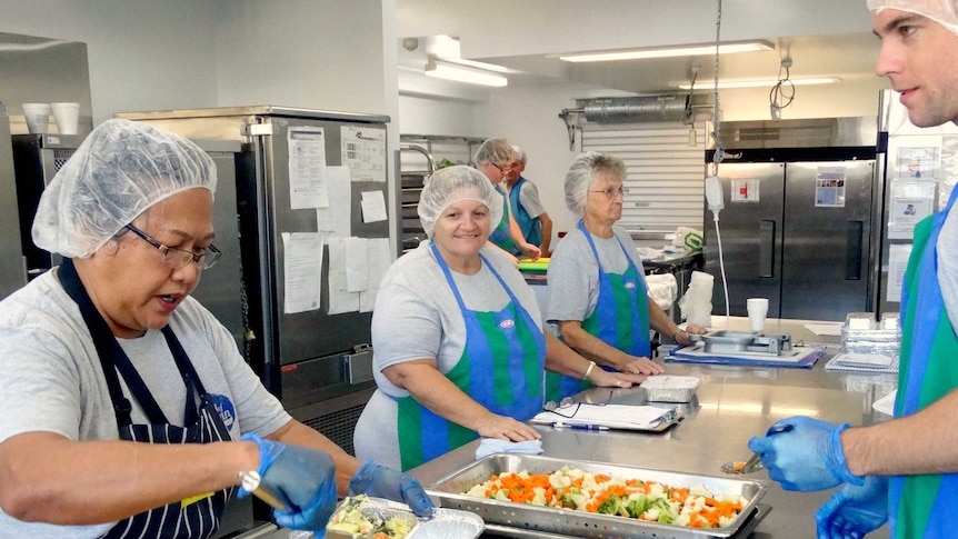 Chef Yanti Kielensty and volunteers Carol Daniels and Margaret King prepare the meals ready for delivery.