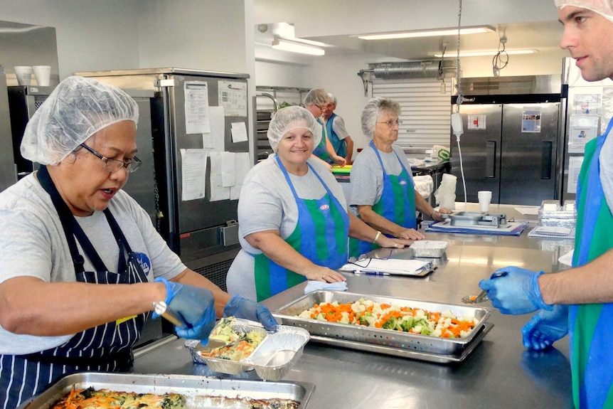 Chef Yanti Kielensty and volunteers Carol Daniels and Margaret King prepare the meals ready for delivery.