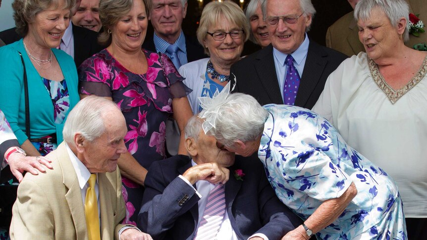Doreen Luckie, aged 91, kisses her husband George Kirby, aged 103.
