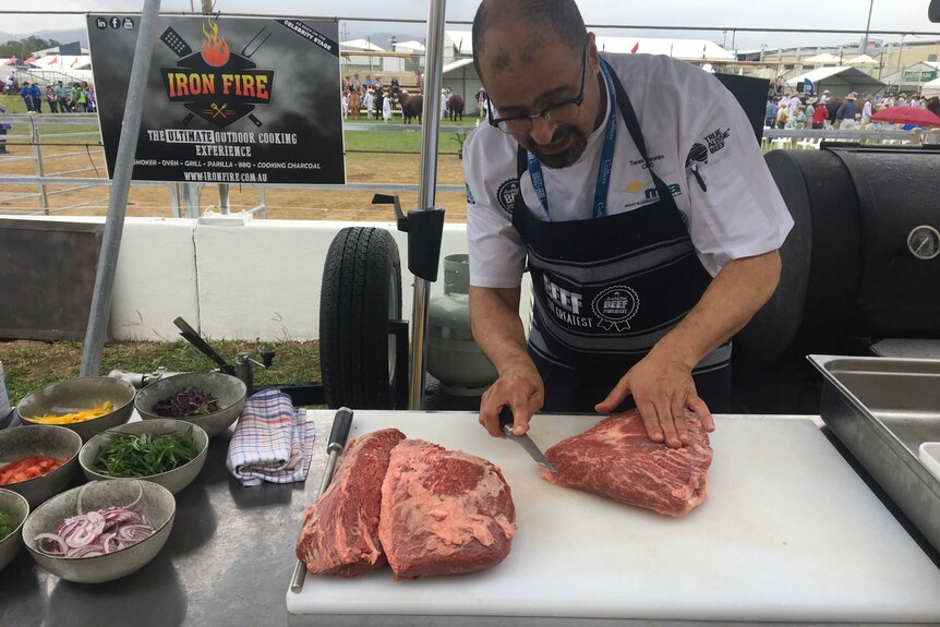 Famous chef Tariq Ibraham cuts some beef up with a knife.