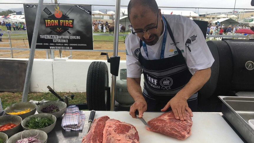 Famous chef Tariq Ibraham cuts some beef up with a knife.