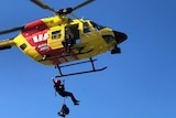 Helicopter winching crewman