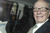 Murdoch reads papers on way to office