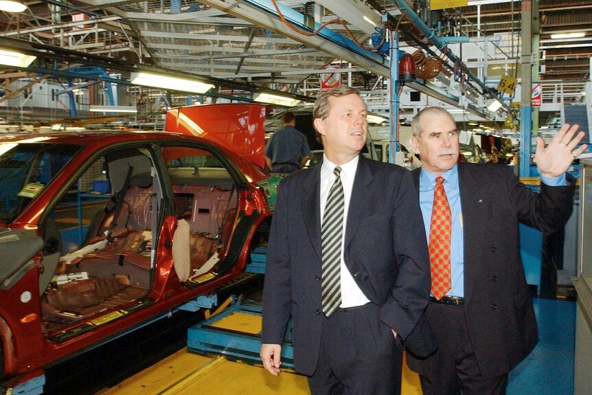 Tom Phillips shows then premier Mike Rann around a car manufacturing production line