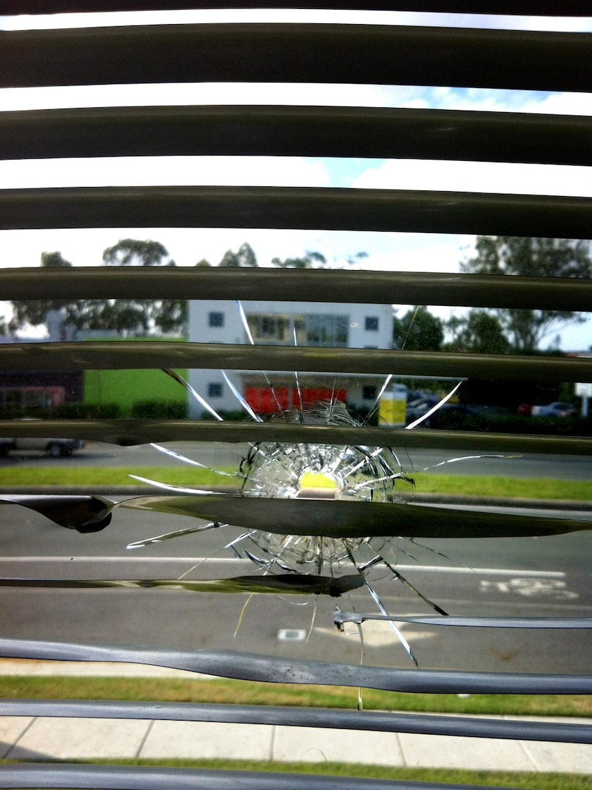 Bullet hole in window of Michael Crandon's electorate office.