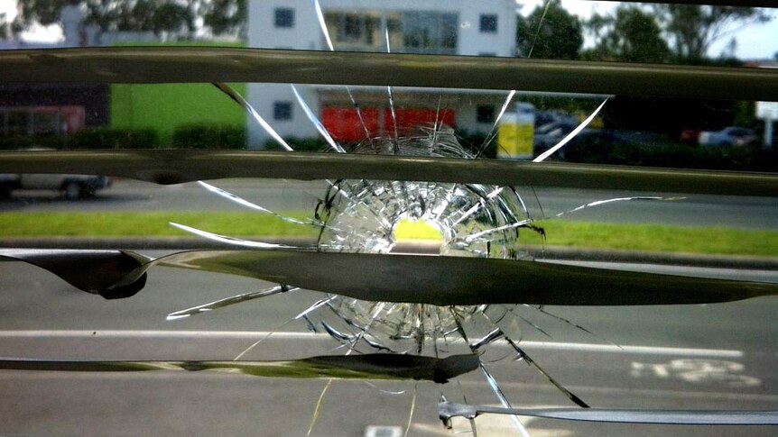 Bullet hole in window of Michael Crandons electorate office.