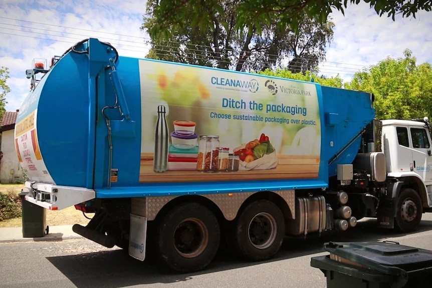 A Cleanaway truck picks up bins along a street in Carlisle in the Town of Victoria Park.