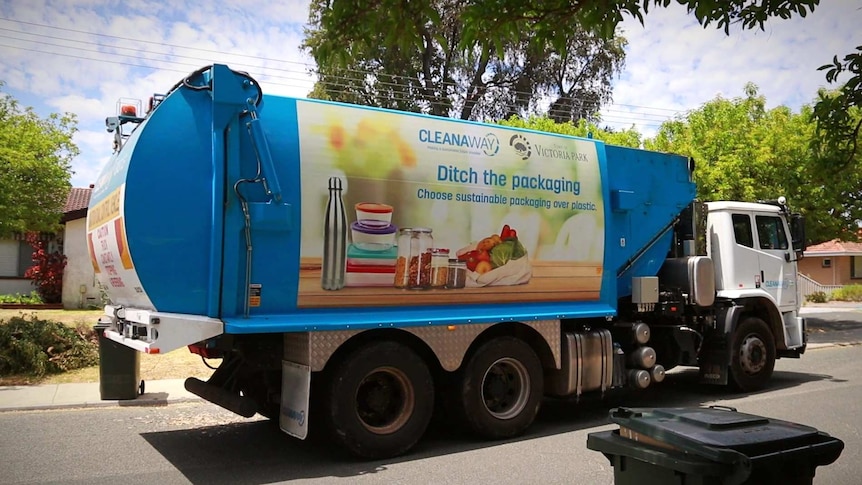 A Cleanaway truck picks up bins along a street in Carlisle in the Town of Victoria Park.