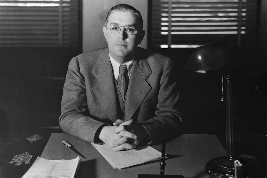 Film censor Joseph Breen sitting in his office in 1935, black and white.