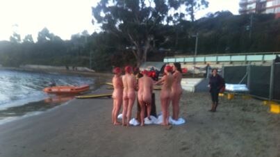 Nude participants warm up after their skinny dip at Dark Mofo festival.
