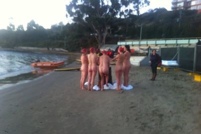 Nude participants warm up after their skinny dip at Dark Mofo festival.