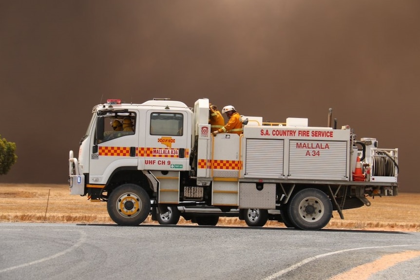 Fire unit drives near thick smoke of a blaze