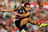 Andrew McLeod of the Crows kicks for goal (action pic)