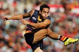 Andrew McLeod of the Crows kicks for goal (action pic)