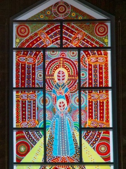 A brightly-coloured stained glass windows with Aboriginal designs.