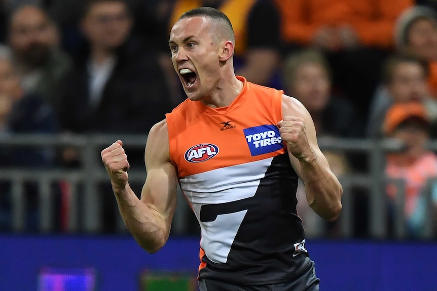 Tom Scully screams as he pumps his two fists after scoring a goal for the Giants.