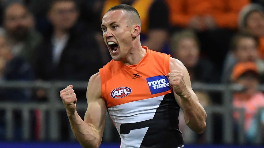 Tom Scully screams as he pumps his two fists after scoring a goal for the Giants.