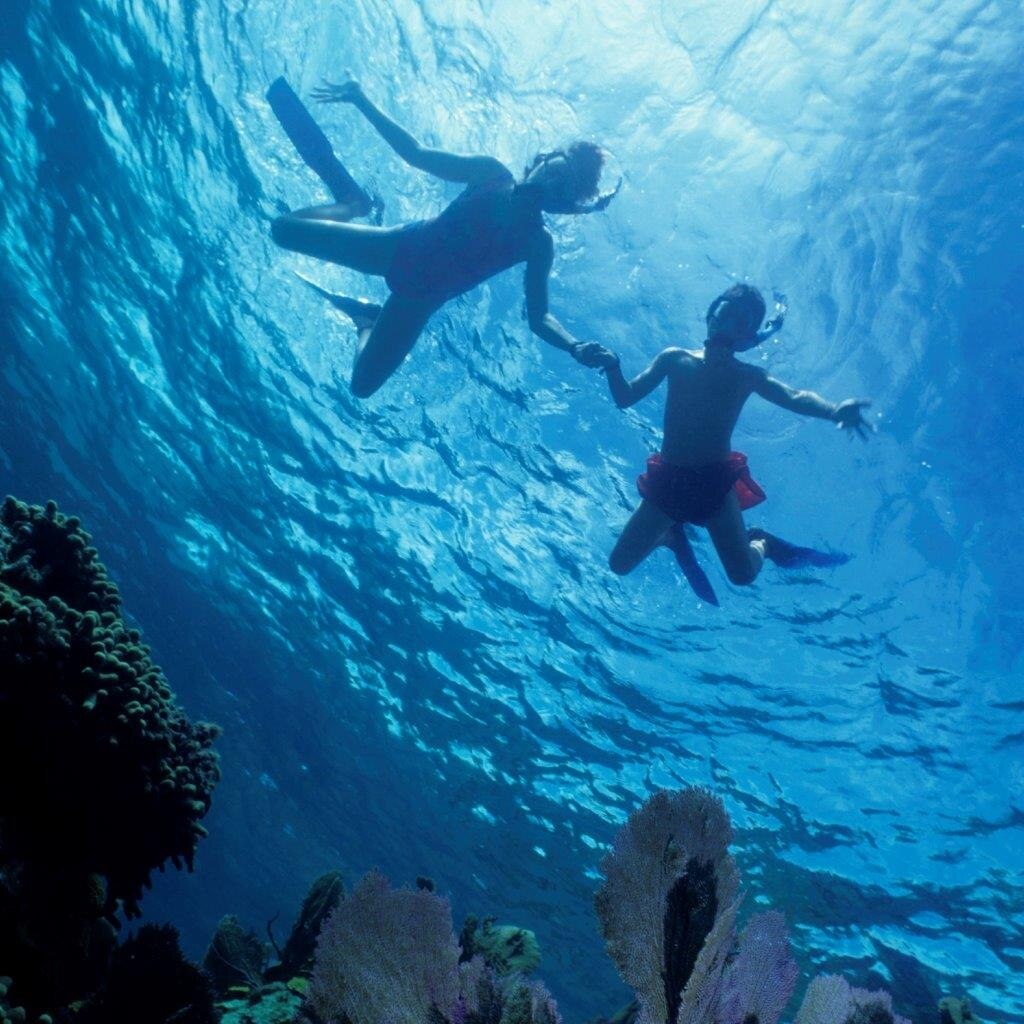 Two children snorkling.