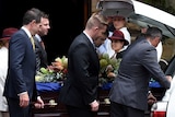 Pallbearers carry the coffin of Kel Nagle