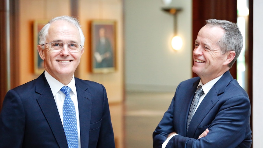 PM Malcolm Turnbull and Opposition Leader Bill Shorten chat in the hallway of Parliament House