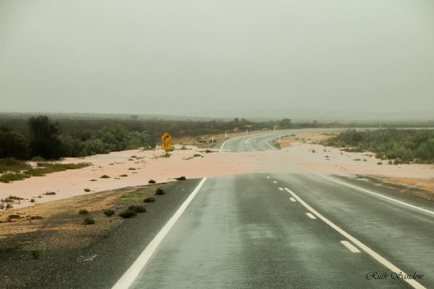a major bitumen road cut by a wide stream of water