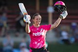 Ashleigh Gardner raises her bat to acknowledge the crowd after reaching her half-century in the WBBL.
