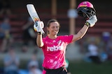 Ashleigh Gardner raises her bat to acknowledge the crowd after reaching her half-century in the WBBL.