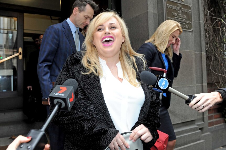 Actress Rebel Wilson laughs outside the Supreme Court in Melbourne.