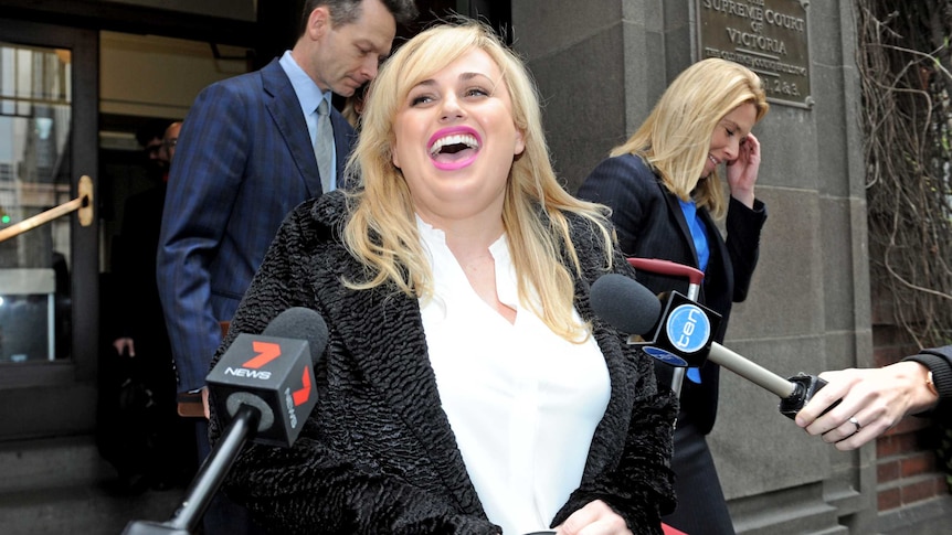 Actress Rebel Wilson laughs outside the Supreme Court in Melbourne.