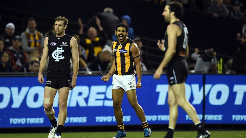 Dominant performance ... Cyril Rioli (C) celebrates a Hawthorn goal against Carlton