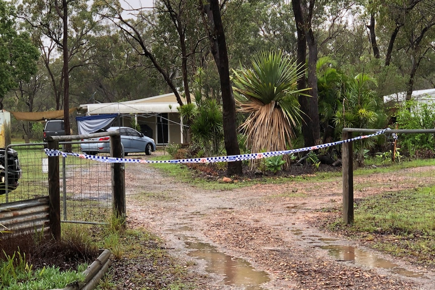 Police tape blocks off the driveway to the house where a man was stabbed to death.