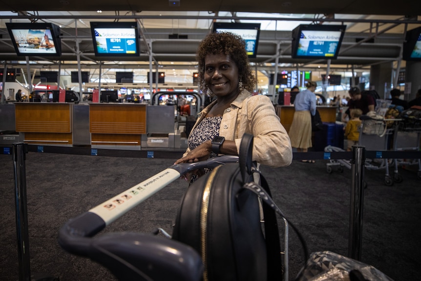 A woman in an airport smiling