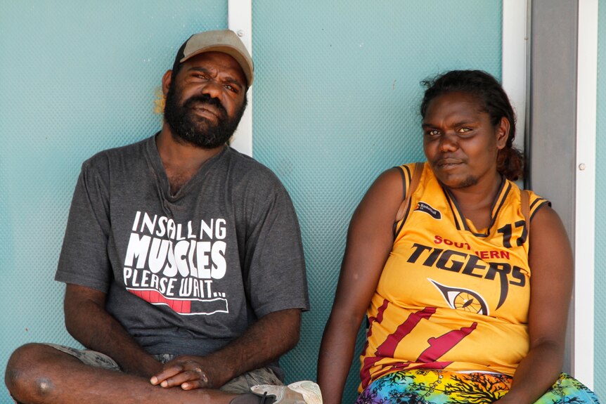 An Aboriginal man and woman sit together. 